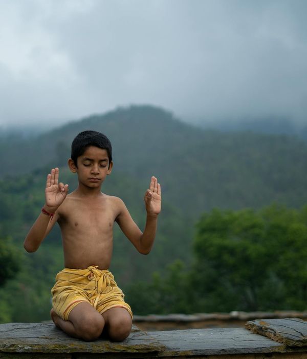 Woman practicing a calm breathing exercise in a serene environment.